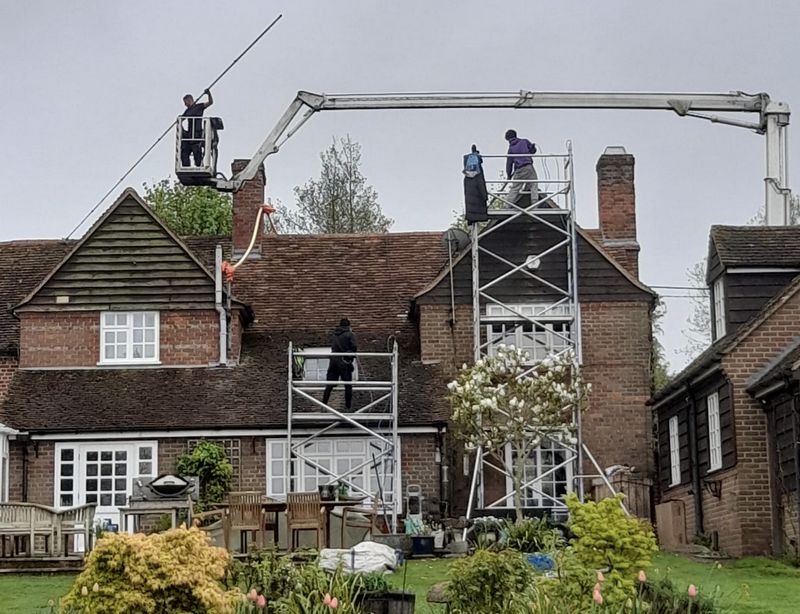 The Roof Moss Cleaners using cherry picker and scaffolding to clean roof safely and professionally in Stotfold, Bedfordshire